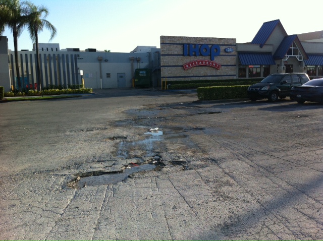 Potholes in a Parking Lot With Trucks